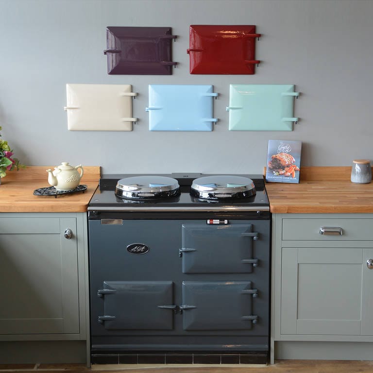 A re-enamelled Aga in the John Wray showroom, with enamel colour panels on the wall behind